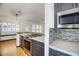 Open kitchen with stainless steel appliances and eat-in counter overlooking a dining area at 18802 N 71St Ln, Glendale, AZ 85308