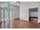Bright and airy living room with hardwood floors, ceiling fan and access to the patio through french doors at 18802 N 71St Ln, Glendale, AZ 85308