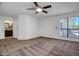 Spacious main bedroom featuring neutral carpet and a ceiling fan, with large windows providing ample natural light at 18802 N 71St Ln, Glendale, AZ 85308