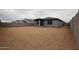 New construction backyard with a block wall, providing privacy and defining the outdoor space at 1917 S 246Th Ln, Buckeye, AZ 85326
