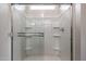 Modern bathroom shower with glass sliding doors and built-in shelving for a luxurious bathing experience at 1917 S 246Th Ln, Buckeye, AZ 85326
