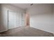 Bedroom offers a comfortable carpeted floor, standard closet with sliding doors, and a doorway into another room at 1917 S 246Th Ln, Buckeye, AZ 85326