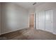 Comfortable bedroom with carpet flooring, standard closet with sliding doors, and neutral colored walls at 1917 S 246Th Ln, Buckeye, AZ 85326