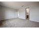 Spacious bedroom with neutral carpet, bright walls, ensuite bathroom, and walk-in closet at 1917 S 246Th Ln, Buckeye, AZ 85326
