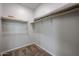 Walk-in closet with wood shelving and carpeted floor, offering ample storage space at 1917 S 246Th Ln, Buckeye, AZ 85326