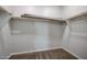Walk-in closet with wood shelving and carpeted floor, offering ample storage space at 1917 S 246Th Ln, Buckeye, AZ 85326