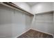Walk-in closet with wood shelving and carpeted floor, offering ample storage space at 1917 S 246Th Ln, Buckeye, AZ 85326