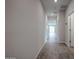 Hallway with tiled floors leads to a sunlit living area, enhancing the sense of spaciousness and openness at 1917 S 246Th Ln, Buckeye, AZ 85326