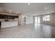 Spacious living room features modern tile flooring, recessed lighting, and large windows at 1917 S 246Th Ln, Buckeye, AZ 85326