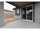 Outdoor patio with sliding glass doors and a window, seamlessly blending indoor and outdoor living at 1917 S 246Th Ln, Buckeye, AZ 85326