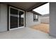 Covered patio with sliding glass doors and a window, seamlessly blending indoor and outdoor living spaces at 1917 S 246Th Ln, Buckeye, AZ 85326