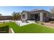 Attractive backyard features a large patio area, artificial grass, and manicured landscaping at 1919 W Plum Rd, Phoenix, AZ 85085