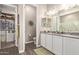 Bathroom featuring a walk-in closet, double sinks, and granite countertops for a luxurious feel at 1919 W Plum Rd, Phoenix, AZ 85085