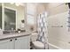 Well-lit bathroom with a modern vanity, stylish decor, and shower-tub combination at 1919 W Plum Rd, Phoenix, AZ 85085