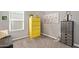 Bright bedroom featuring a large window, yellow filing cabinet and stylish decorations at 1919 W Plum Rd, Phoenix, AZ 85085
