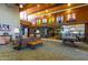 A clubhouse sitting area featuring comfortable couches, chairs, decor, and recreational items at 1919 W Plum Rd, Phoenix, AZ 85085