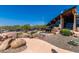 Exterior view of community building with lush desert landscaping, rocks, and shrubs at 1919 W Plum Rd, Phoenix, AZ 85085