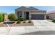 Inviting single-story home with a two car garage, manicured landscaping and walkway to the front door at 1919 W Plum Rd, Phoenix, AZ 85085