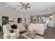 Open-concept living room with a ceiling fan, tile floors, comfortable seating and natural light at 1919 W Plum Rd, Phoenix, AZ 85085