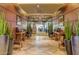 Interior lobby with tiled floor, tables, seating, and plants at 1919 W Plum Rd, Phoenix, AZ 85085