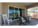 Relaxing covered patio with comfortable seating and view to the outdoor landscape at 1919 W Plum Rd, Phoenix, AZ 85085