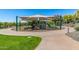 Community playground with climbing structure, slides, shade cover, and winding walking paths at 1919 W Plum Rd, Phoenix, AZ 85085