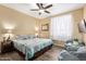 Comfortable bedroom with a ceiling fan, two chairs, and natural light coming through the window at 1941 S Pierpont Dr # 1099, Mesa, AZ 85206