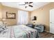 Bedroom with a TV, two chairs, and a comfortable bed with a patterned comforter at 1941 S Pierpont Dr # 1099, Mesa, AZ 85206