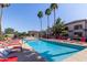 Enjoy this community pool with ample lounge seating and palm trees, perfect for relaxation at 1941 S Pierpont Dr # 1099, Mesa, AZ 85206