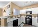 Charming kitchen with white cabinets, modern appliances, and stylish wood-look flooring at 1941 S Pierpont Dr # 1099, Mesa, AZ 85206