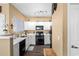 Bright kitchen features white cabinets, modern appliances, and wood-look flooring at 1941 S Pierpont Dr # 1099, Mesa, AZ 85206