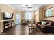 Inviting living room features a ceiling fan, stylish furniture, and attractive wood-look flooring at 1941 S Pierpont Dr # 1099, Mesa, AZ 85206