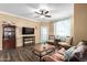 Comfortable living room features an entertainment center and stylish furnishings and wood-look flooring at 1941 S Pierpont Dr # 1099, Mesa, AZ 85206