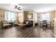 A beautiful dining area and living room space featuring wood-look flooring and stylish furniture at 1941 S Pierpont Dr # 1099, Mesa, AZ 85206