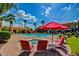 Beautiful community pool area with red umbrellas, lounge chairs and relaxing spa at 1941 S Pierpont Dr # 1099, Mesa, AZ 85206