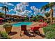 Community pool featuring lounge seating and vibrant landscaping at 1941 S Pierpont Dr # 1099, Mesa, AZ 85206