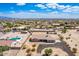 Expansive aerial view featuring a home with pool and lush greenery, showcasing community charm at 20041 W Colter St, Litchfield Park, AZ 85340