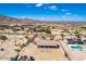 Expansive aerial view of desert home with a tile roof, pool, large lot and mountain views in the distance at 20041 W Colter St, Litchfield Park, AZ 85340