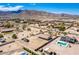 Scenic aerial view of desert home featuring solar panels, pool, large lot, and mountain views in the background at 20041 W Colter St, Litchfield Park, AZ 85340