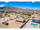 Scenic aerial view of desert home featuring solar panels, pool, large lot, and mountain views in the background at 20041 W Colter St, Litchfield Park, AZ 85340