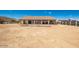 Spacious backyard featuring desert landscaping, partial fencing, and covered patio at 20041 W Colter St, Litchfield Park, AZ 85340