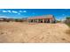 Spacious backyard featuring desert landscaping, partial fencing, and covered patio at 20041 W Colter St, Litchfield Park, AZ 85340