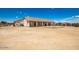 Spacious backyard featuring desert landscaping, partial fencing, and covered patio at 20041 W Colter St, Litchfield Park, AZ 85340