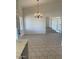 Bright dining area featuring a chandelier and neutral tile flooring at 20041 W Colter St, Litchfield Park, AZ 85340