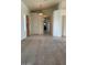 Inviting hallway featuring neutral-toned walls, carpet floors and elegant chandelier lighting at 20041 W Colter St, Litchfield Park, AZ 85340
