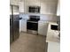 A view of the updated kitchen with stainless steel appliances and white cabinetry at 20041 W Colter St, Litchfield Park, AZ 85340