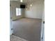 A view of the carpeted living room with natural light and ceiling fan at 20041 W Colter St, Litchfield Park, AZ 85340