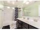 Well-maintained bathroom featuring double sinks, tile flooring, and stylish decor at 20709 W Delaney Dr, Buckeye, AZ 85396