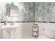 Stylish half bath with a pedestal sink, wallpaper, and modern fixtures at 20709 W Delaney Dr, Buckeye, AZ 85396