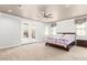 Inviting bedroom with access to the backyard, featuring a ceiling fan and neutral carpet at 20709 W Delaney Dr, Buckeye, AZ 85396